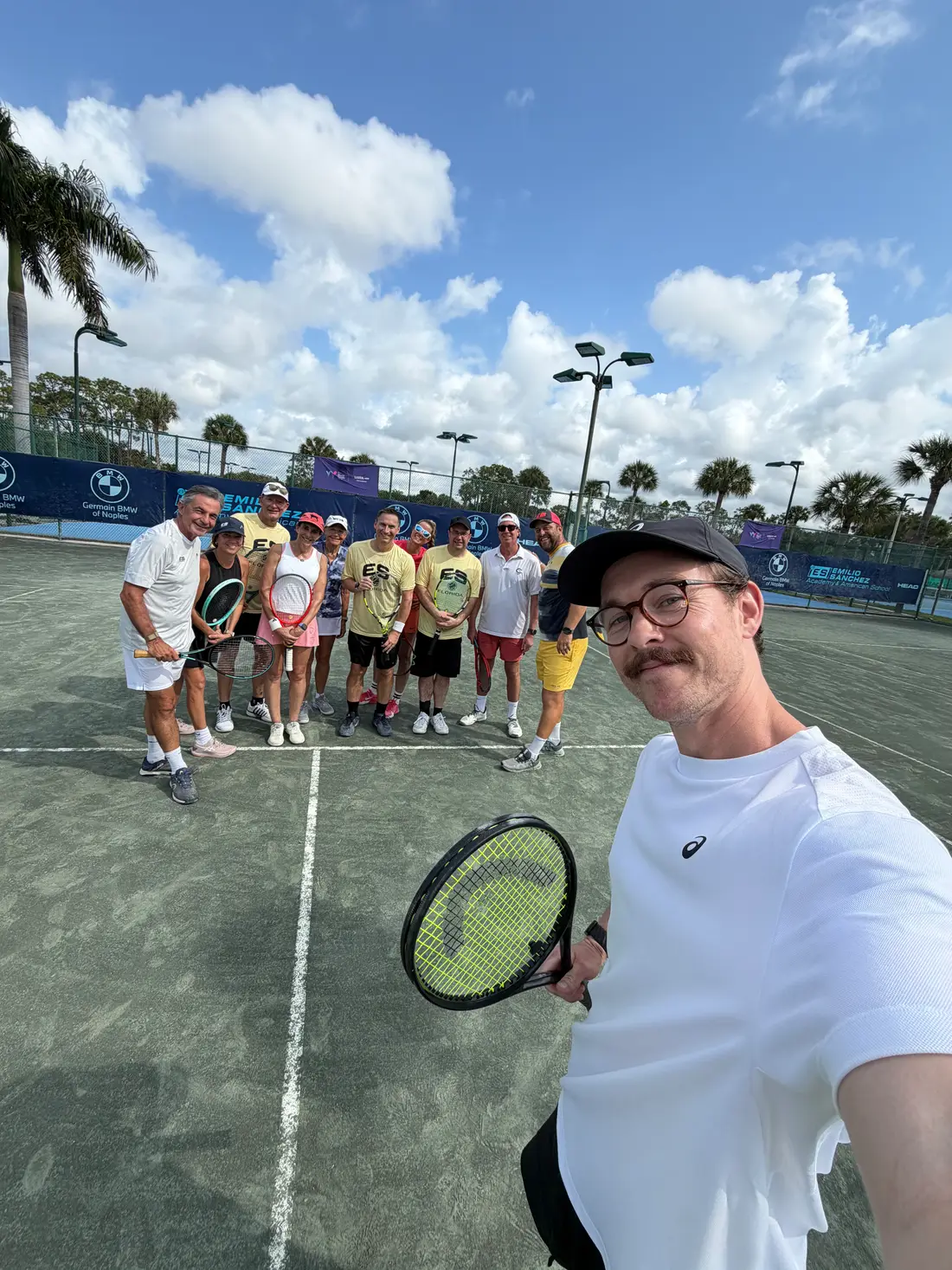 Ashley Neaves with players at a tennis camp