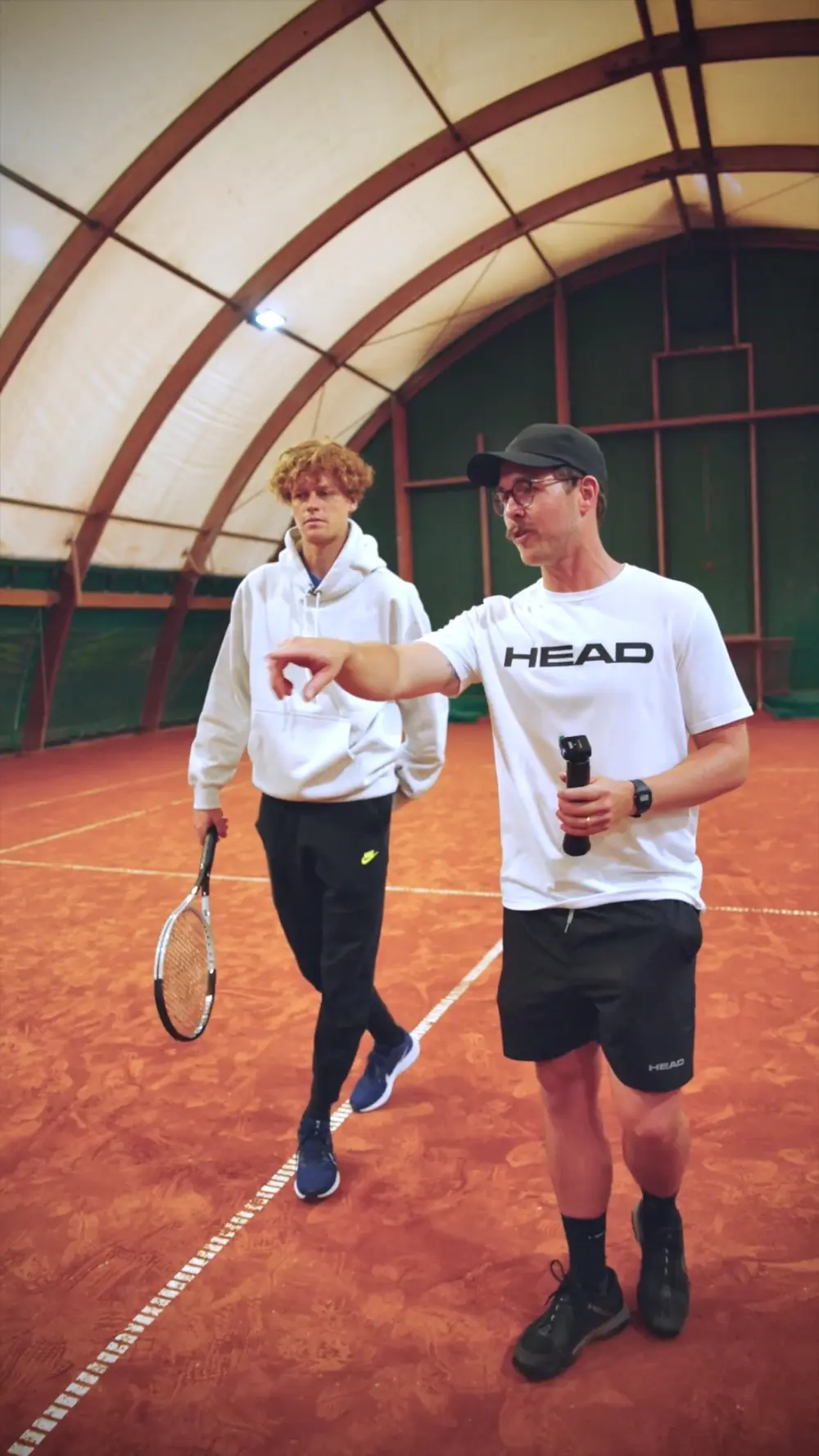 Ashley Neaves coaching on a clay court